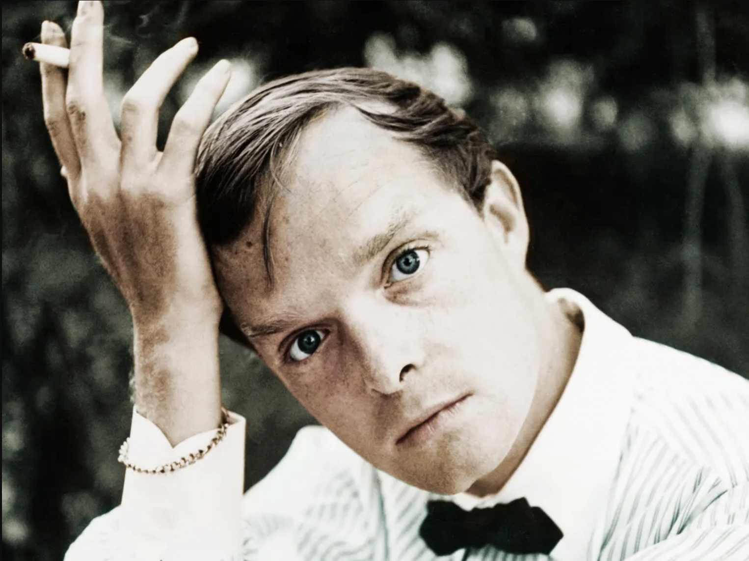 A portrait of Truman Capote smoking a cigarette.
